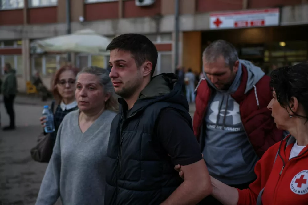 A man is comforted outside a hospital, following a fire in a night club resulting in casualties, in the town of Kocani, North Macedonia, March 16, 2025. REUTERS/Alexandros Avramidis