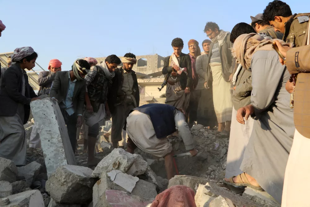 People gather on the rubble of a house hit by a U.S. strike in Saada, Yemen March 16, 2025. REUTERS/Naif Rahma