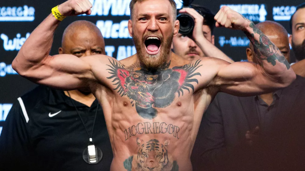 ﻿FILE PHOTO: UFC lightweight champion Conor McGregor of Ireland poses on the scale during his official weigh-in at T-Mobile Arena in Las Vegas, Nevada, U.S. on August 25, 2017.  REUTERS/Steve Marcus/File Photo