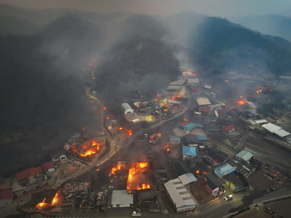 Houses burn in a village after being engulfed by a wildfire fueled by strong winds in Uiseong, South Korea, Tuesday, March 25, 2025. (Yoon Gwan-shick/Yonhap via AP)
