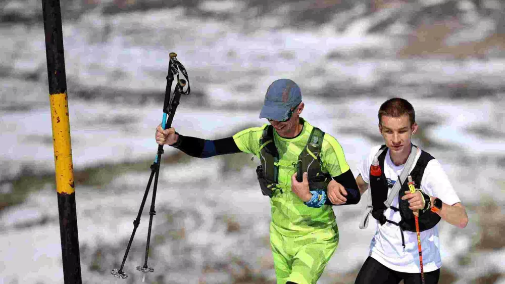 Victor Asenov, a visually impaired ultramarathon runner, is guided by pacer Pavlin Beev as he attempts to cover the same elevation as Mount Everest, an activity known as 'Everesting', by running up and down the Black Peak summit of the Vitosha mountain, to raise awareness of a guide dog school, near Sofia, Bulgaria, March 21, 2025. REUTERS/Spasiyana Sergieva