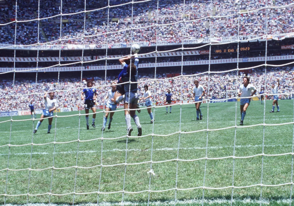 ﻿Diego Maradona, Argentina, scoring the legendary "Hand of God" goal during the England - Argentina (1:2) match at the 1990 FIFA World Cup in Mexico. Photo by: Sven Simon/picture-alliance/dpa/AP Images