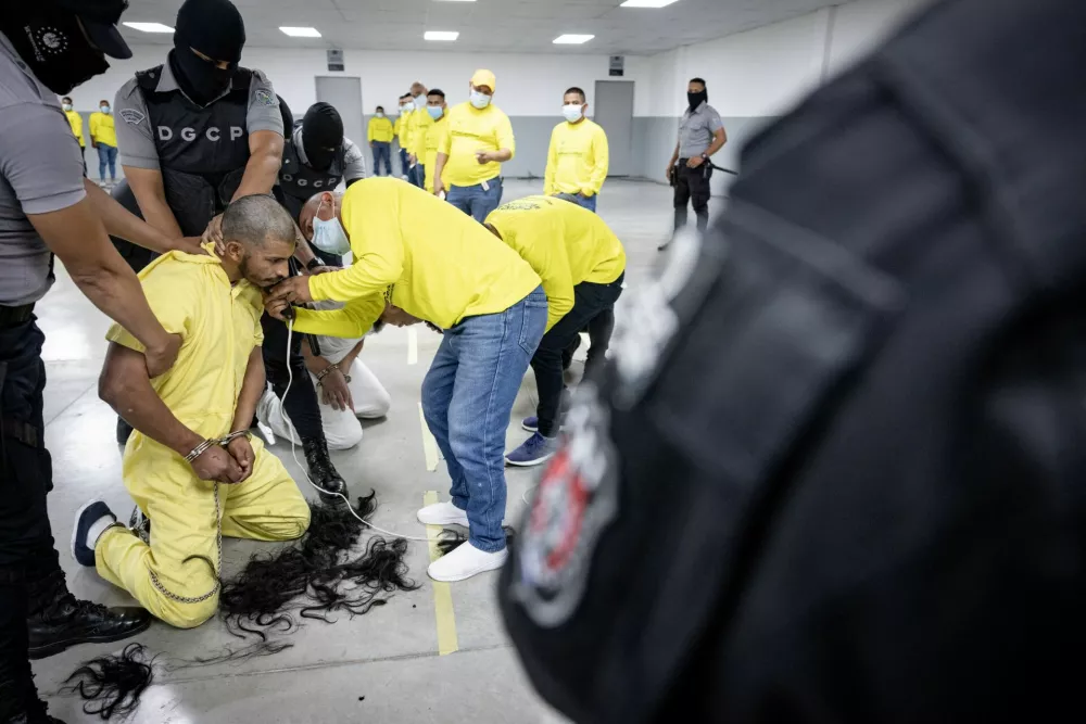 Salvadoran police officers cut the hair of an alleged member of the Venezuelan gang Tren de Aragua recently deported by the U.S. government to be imprisoned in the Terrorism Confinement Center (CECOT) prison, as part of an agreement with the Salvadoran government, in Tecoluca, El Salvador, in this handout image obtained March 16, 2025. Secretaria de Prensa de la Presidencia/Handout via REUTERS ATTENTION EDITORS - THIS IMAGE HAS BEEN SUPPLIED BY A THIRD PARTY. NO RESALES. NO ARCHIVES