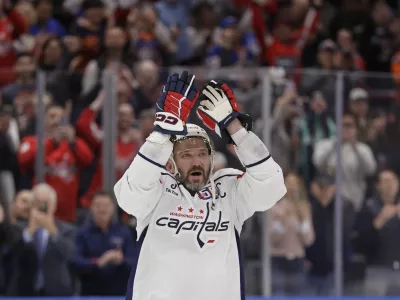 Washington Capitals left wing Alex Ovechkin (8) celebrates after scoring his 895th career goal during the second period of an NHL hockey game against New York Islanders in Elmont, N.Y., Sunday, April 6, 2025. (AP Photo/Adam Hunger)