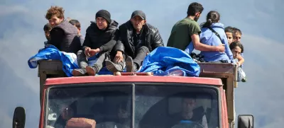 FILE PHOTO: Refugees from Nagorno-Karabakh region ride in a truck upon their arrival at the border village of Kornidzor, Armenia, September 27, 2023. REUTERS/Irakli Gedenidze   TPX IMAGES OF THE DAY/File Photo