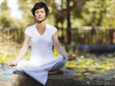 middle aged woman doing yoga meditation