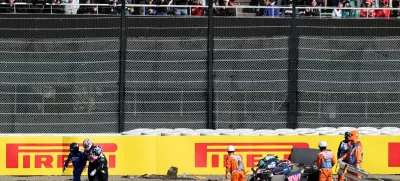 Formula One F1 - Japanese Grand Prix - Suzuka Circuit, Suzuka, Japan - April 4, 2025 Alpine's Jack Doohan walks away with a medical team as marshals attend his car after the crashing during practice REUTERS/Issei Kato