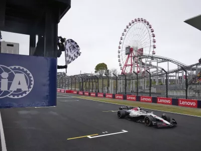 Red Bull driver Max Verstappen of the Netherlands receives the checkered flag as he crosses the finish line to win the Japanese Formula One Grand Prix at the Suzuka Circuit in Suzuka, central Japan, Sunday, April 6, 2025. (AP Photo/Shuji Kajiyama, Pool)