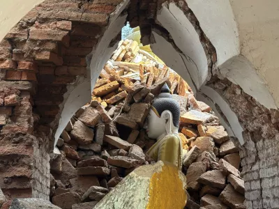 A damaged pagoda is partially buried in earthquake rubble in the Amarapura township, Mandalay, Myanmar, April 2, 2025. (AP Photo)