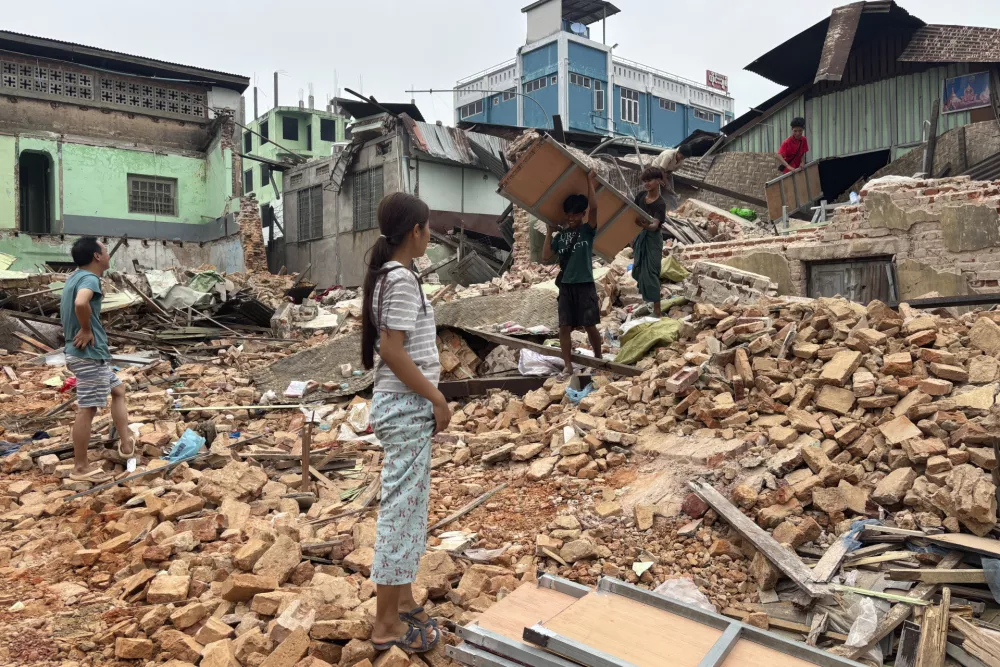 People clean debris from damaged buildings in the aftermath of an earthquake on March 28, in Naypyitaw, Myanmar, Monday, April 7, 2025. (AP Photo)