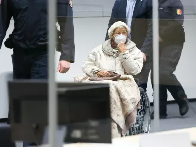 FILED - 20 December 2022, Itzehoe: The defendant Irmgard F.,charged with aiding mass murder in over 11,000 cases in the Stutthof concentration camp, is brought into the courtroom at the beginning in Itzehoe. The 99-year-old former secretary at the Stutthof concentration camp convicted for aiding and abetting the mass murder of more than 10,000 people between June 1943 and April 1945 has died, prosecutors said on Monday. Photo: Christian Charisius/dpa/Pool/dpa