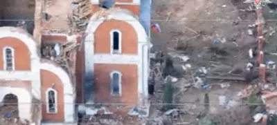 A Russian flag flies from the window of a destroyed church in the village of Guyevo, which was recently retaken by Russia's armed forces, according to the Russian Defence Ministry, in the course of Russia-Ukraine conflict in the Kursk region, Russia, in this still image taken from video released April 8, 2025. Russian Defence Ministry/Handout via REUTERS ATTENTION EDITORS - THIS IMAGE HAS BEEN SUPPLIED BY A THIRD PARTY. NO RESALES. NO ARCHIVES. MANDATORY CREDIT. WATERMARK FROM SOURCE.