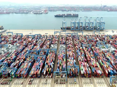 FILE PHOTO: An aerial view shows containers and cargo vessels at the Qingdao port in Shandong province, China May 9, 2022. Picture taken with a drone. China Daily via REUTERS ATTENTION EDITORS - THIS IMAGE WAS PROVIDED BY A THIRD PARTY. CHINA OUT./File Photo