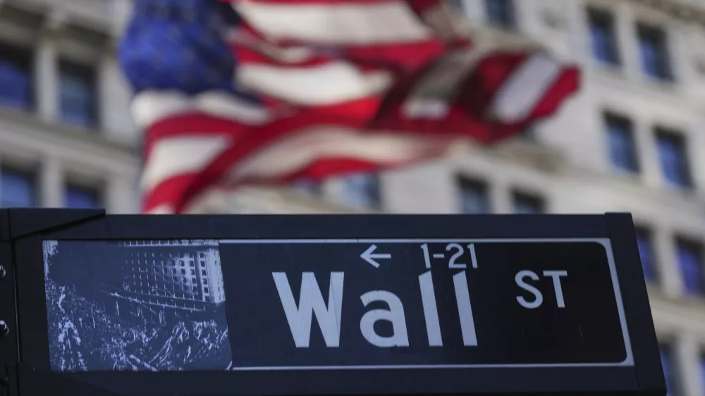 A Wall St. sign is seen near the New York Stock Exchange in New York, Tuesday, April 8, 2025. (AP Photo/Seth Wenig)