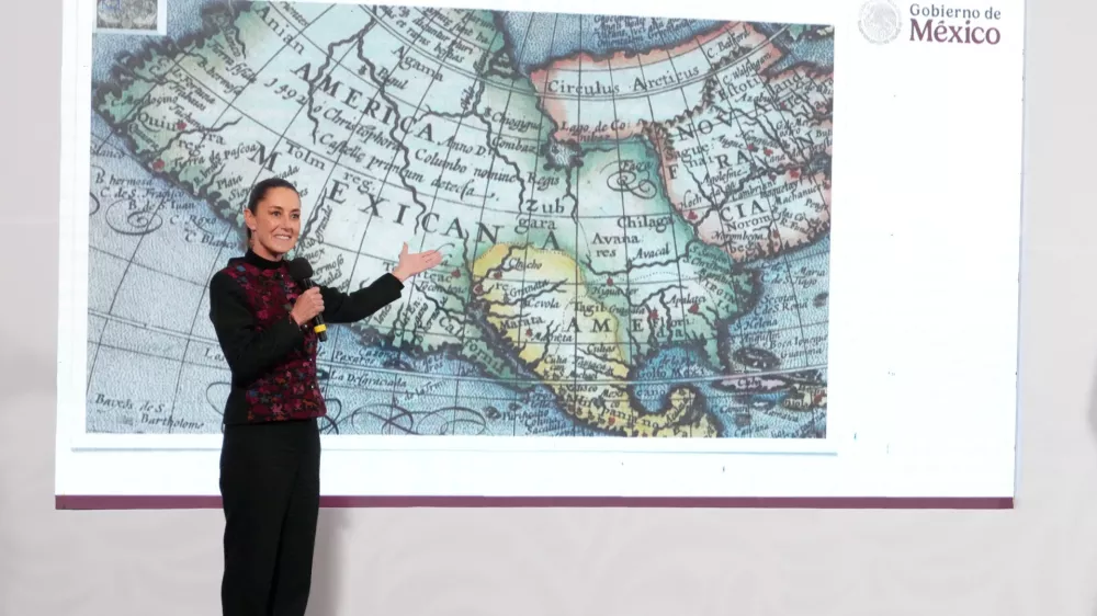 Mexico's President Claudia Sheinbaum shows a 1661 world map showing the Americas and the Gulf of Mexico in response to U.S. President-elect Donald Trump's comments about renaming the body of water, during a press conference at National Palace in Mexico City, Mexico, in this photo distributed on January 8, 2025. Presidencia de Mexico/Handout via REUTERS ATTENTION EDITORS - THIS IMAGE HAS BEEN SUPPLIED BY A THIRD PARTY. NO RESALES. NO ARCHIVES.