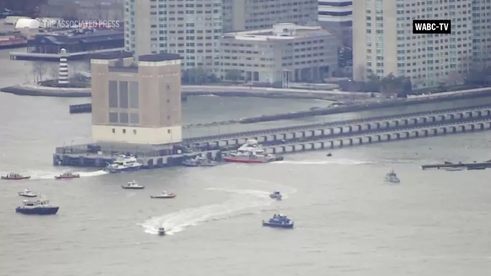 This aerial image taken from video shows rescue vessels on site of helicopter crash on the Hudson River in New York, Thursday, April 10, 2025. (WABC-TV via AP)