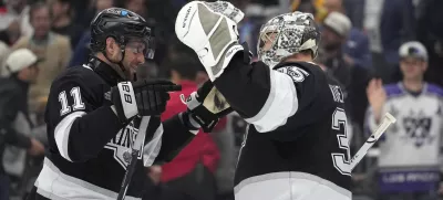 Los Angeles Kings center Anze Kopitar, left, and goaltender Darcy Kuemper congratulate each other after the Kings defeated the Anaheim Ducks in an NHL hockey game Thursday, April 10, 2025, in Los Angeles. (AP Photo/Mark J. Terrill)