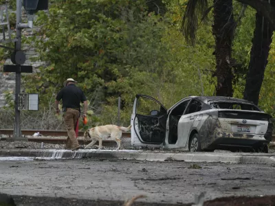 Emergency personnel respond to the area where a small plane crashed on the railroad tracks beneath the overpass near Interstate 95 in Boca Raton, Fla., on Friday, April 11, 2025. (AP Photo/Marta Lavandier)