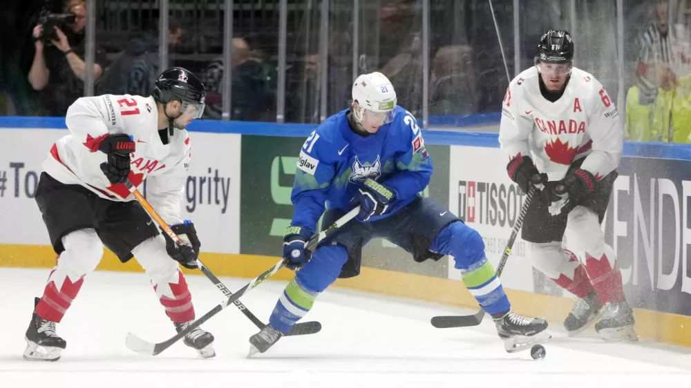 Ice Hockey - IIHF World Ice Hockey Championship 2023 - Group B - Slovenia v Canada - Arena Riga, Riga, Latvia - May 14, 2023 Slovenia's Jan Drozg in action with Canada's Scott Laughton REUTERS/Ints Kalnins