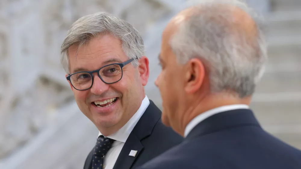 EC Commissioner for home affairs and migrations Magnus Brunner (L) talks with Italian Interior Minister Matteo Piantedosi during theMED-5 Ministers' Meeting on Interior in Naples, Italy