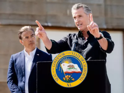 California Gov. Gavin Newsom discusses President Donald Trump's tariffs, as California Attorney General Rob Bonta, left, listens, during a press conference on Wednesday, April 16, 2025, at an almond farm in Ceres, Calif. (AP Photo/Noah Berger)