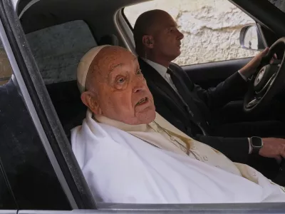 Pope Francis talks to journalists as he leaves at the end of his visit to the Regina Coeli penitentiary in Rome on Holy Thursday, Thursday, April 17, 2025. (AP Photo/Andrew Medichini)