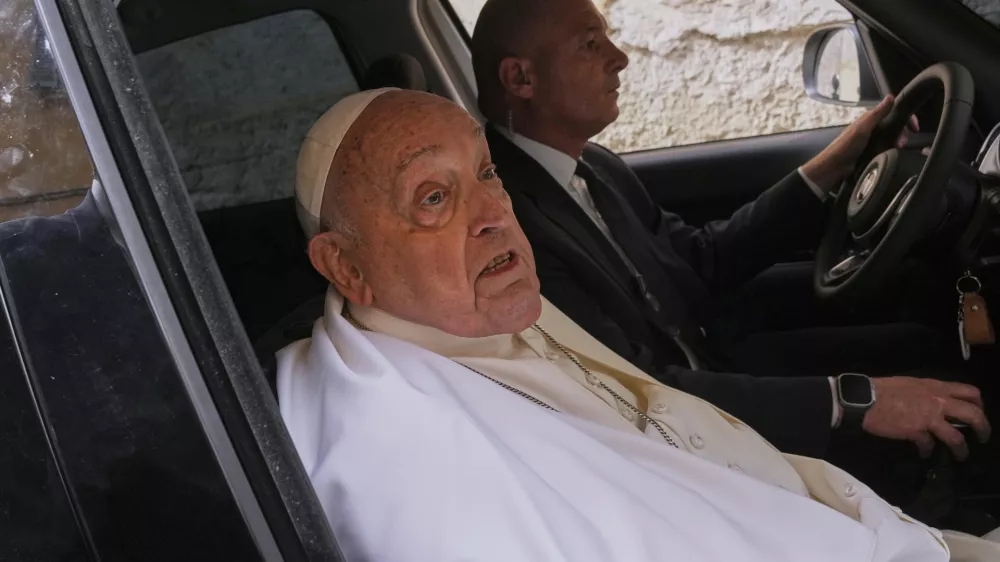 Pope Francis talks to journalists as he leaves at the end of his visit to the Regina Coeli penitentiary in Rome on Holy Thursday, Thursday, April 17, 2025. (AP Photo/Andrew Medichini)