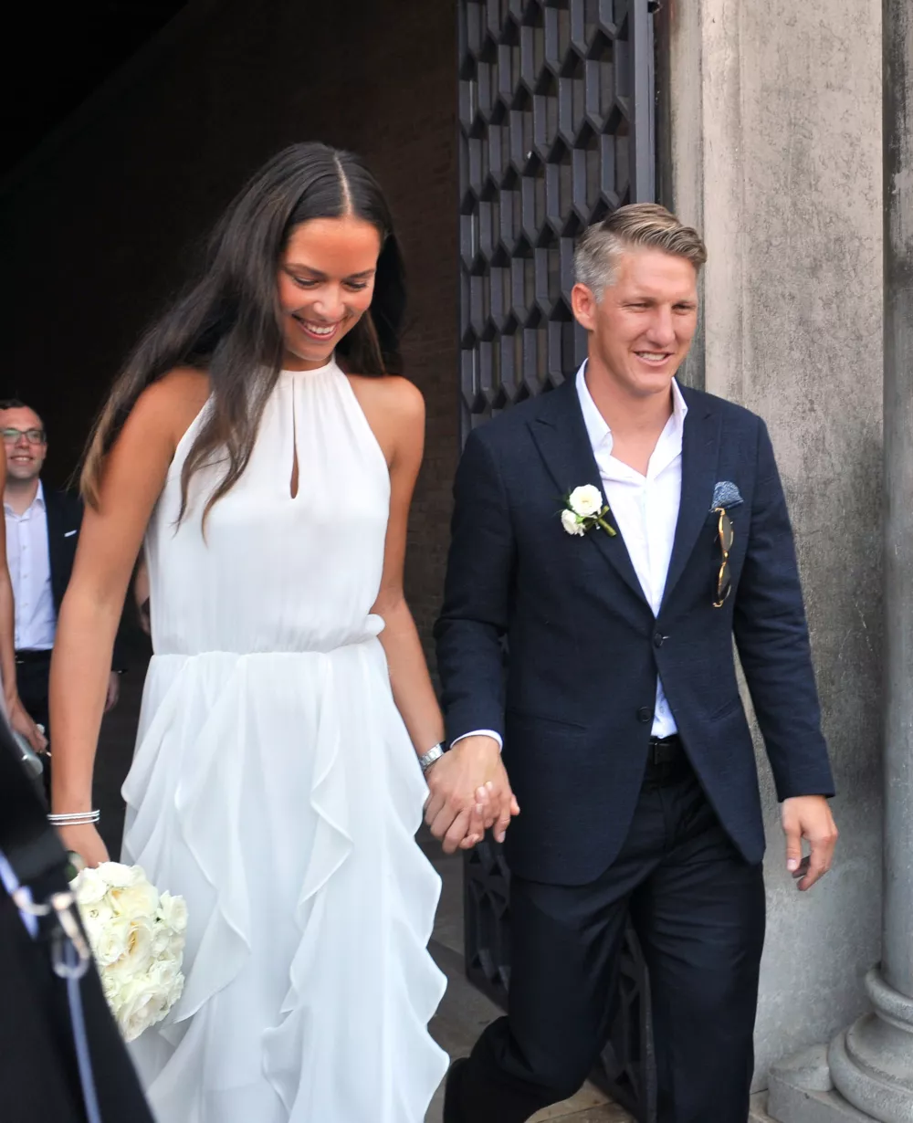 ﻿Tennis player Ana Ivanovic holds hands with Germany soccer player Bastian Schweinsteiger during their wedding, in Venice, Italy, Tuesday, July 12, 2016. (AP Photo/Luigi Costantini)