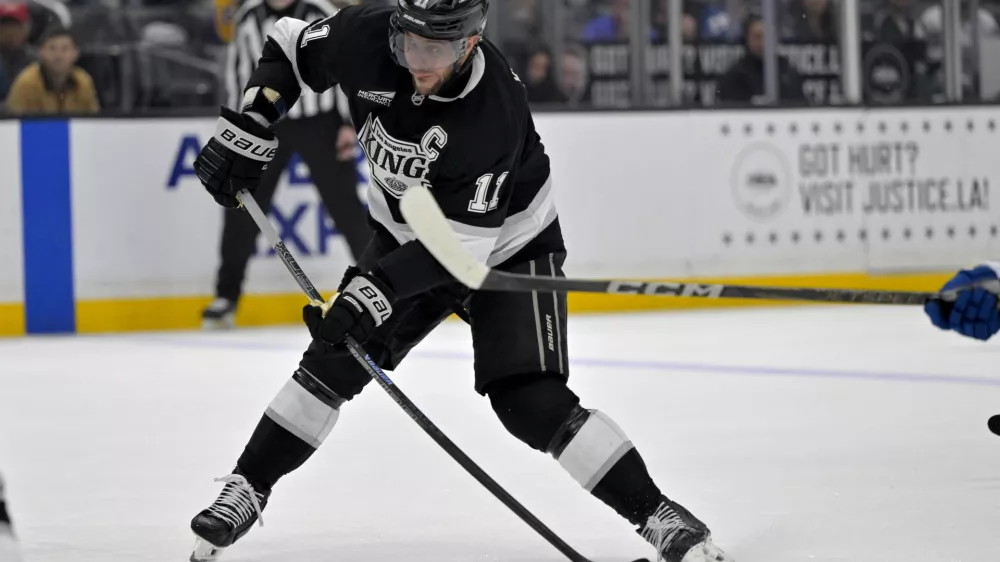 Apr 12, 2025; Los Angeles, California, USA; Los Angeles Kings center Anze Kopitar (11) takes a shot on goal in the second period against the Colorado Avalanche at Crypto.com Arena. Mandatory Credit: Jayne Kamin-Oncea-Imagn Images