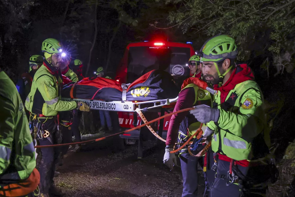 Rescuers recoup the body of one of the victims of a cable car carrying tourists south of Naples which crashed after the cable snapped, killing at least four people and injuring one in Castellamare di Stabia, near Naples, Italy, Thursday, April 17, 2025. (AP Photo/Salvatore Laporta)
