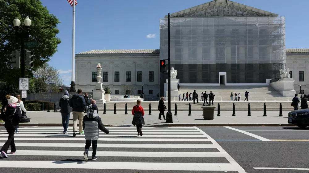 FILE PHOTO: People walk near the U.S. Supreme Court building in Washington, D.C., U.S., April 8, 2025. REUTERS/Jonathan Ernst/File Photo