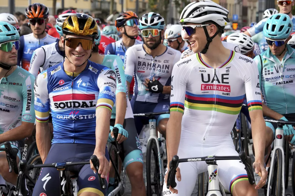 Belgium's Remco Evenepoel, left, and Slovenia's Tadej Pogacar prepare to start the Il Lombardia cycling race in Bergamo, Italy, Saturday, Oct. 12, 2024. (Gian Mattia D'Alberto/LaPresse via AP)
