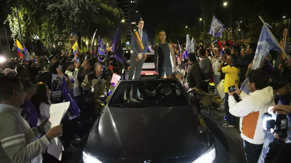 Supporters of President Daniel Noboa celebrate early returns showing him in the lead in the presidential election runoff in Quito, Ecuador, Sunday, April 13, 2025. (AP Photo/Carlos Noriega)