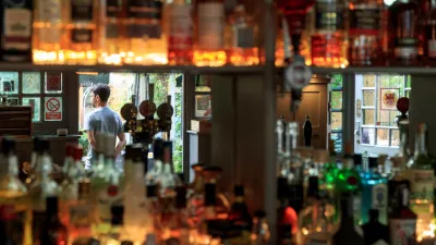 Staff members stand by the entrance of the Red Lion and Sun in London, Britain, August 30, 2022. REUTERS/May James