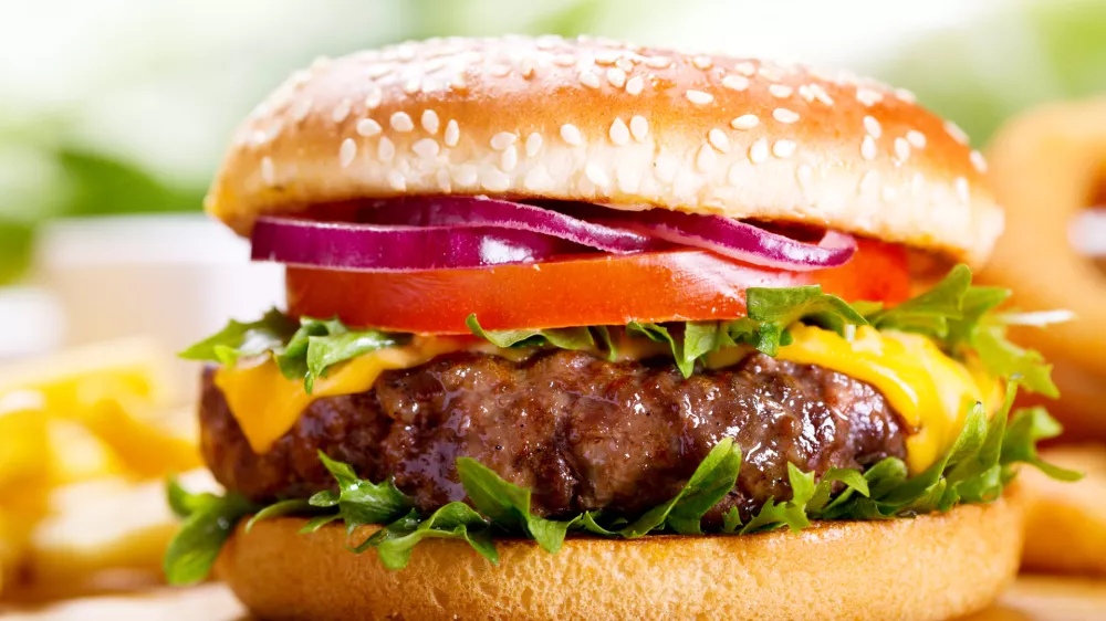 ﻿hamburger with fries on wooden table