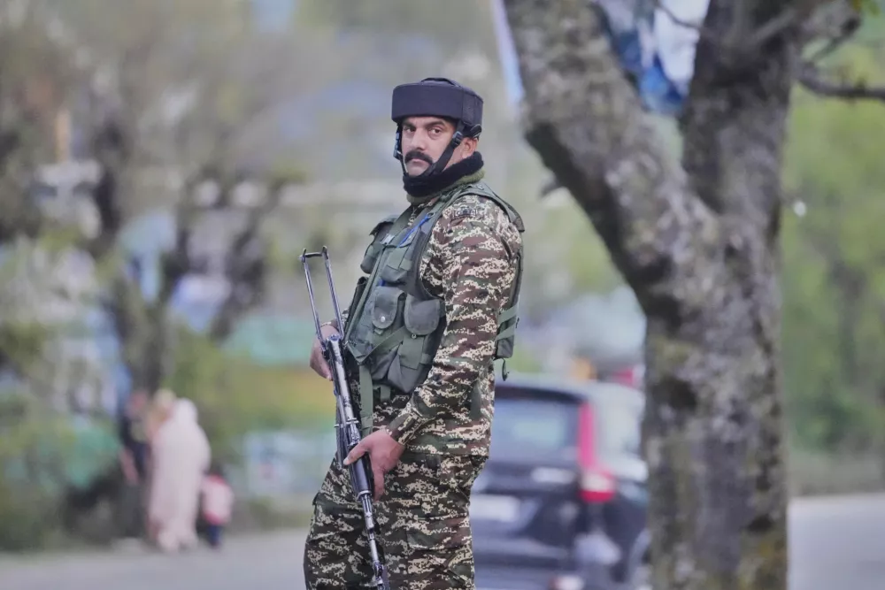 An Indian security officer stands guard in south Kashmir after assailants indiscriminately opened fire on tourists in Pahalgam, Indian controlled Kashmir, Tuesday, April 22, 2025. (AP Photo/Dar Yasin)