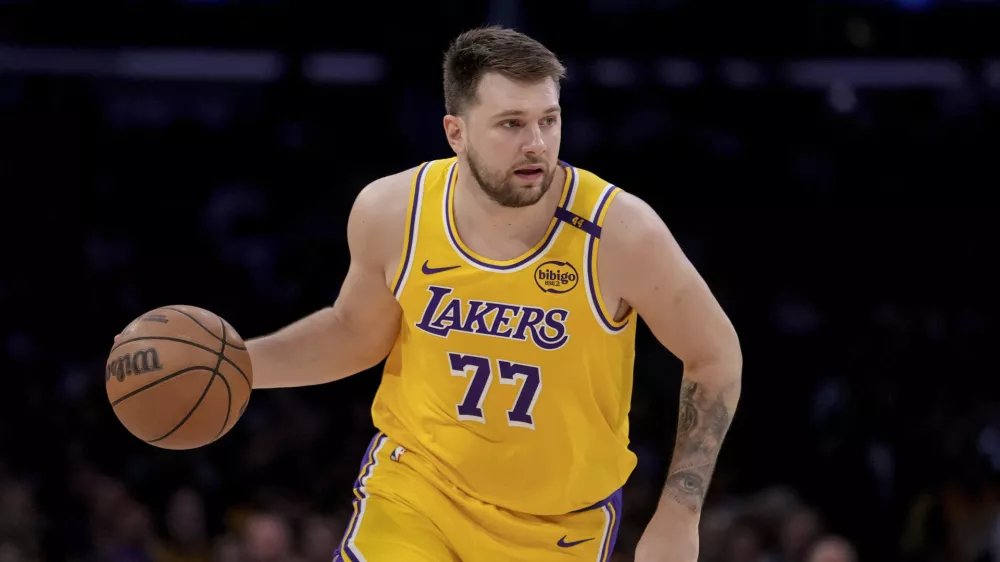 Los Angeles Lakers guard Luka Doncic (77) dribbles up the court during the first half of Game 2 of an NBA first-round playoff series against the Minnesota Timberwolves in Los Angeles, Tuesday, April 22, 2025. (AP Photo/Eric Thayer)