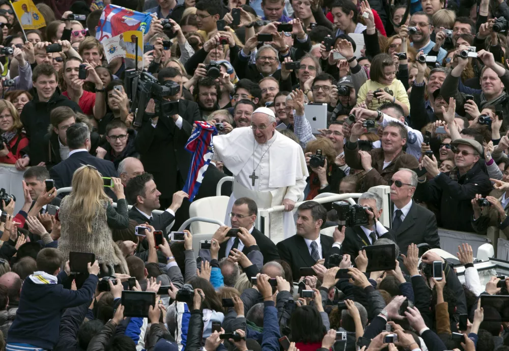 FILE - Pope Francis holds a San Lorenzo soccer jersey after celebrating his first Easter Mass in St. Peter's Square at the Vatican, March 31, 2013. (AP Photo/Alessandra Tarantino, File)