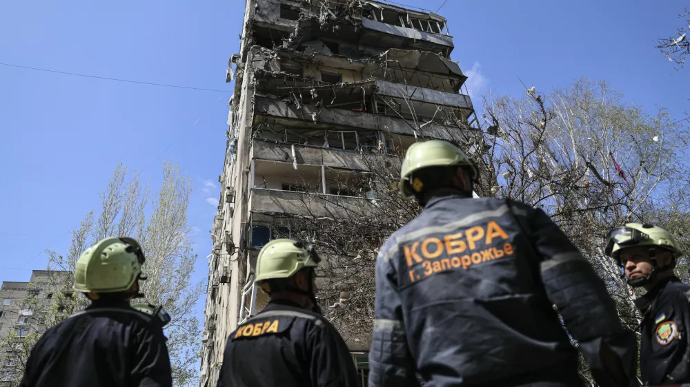 Rescue workers inspect a multi-storey building damaged by a Russian strike on residential neighbourhood in Zaporizhzhia, Ukraine, on Tuesday, April 22, 2025. (AP Photo/Kateryna Klochko)