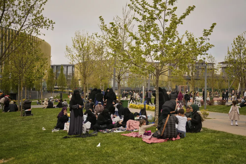 People gather outdoors following an earthquake shock with a preliminary magnitude of 6.2, in Istanbul, Turkey, Wednesday, April 23, 2025. (AP Photo/Khalil Hamra)