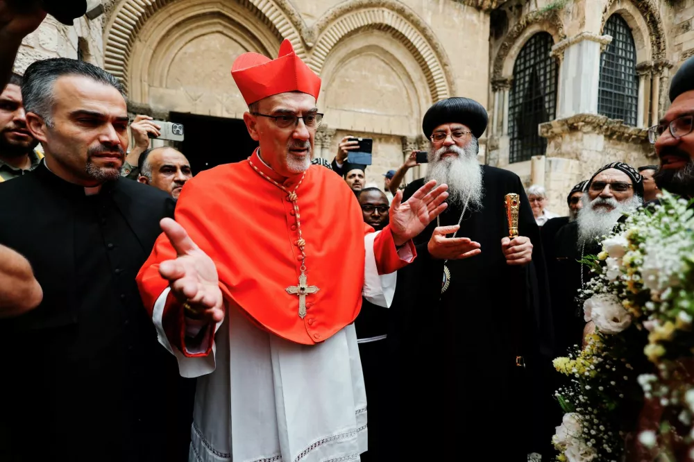 Latin Patriarch of Jerusalem Archbishop Pierbattista Pizzaballa speaks with congregants following Mass for the late Pope Francis at the Church of the Holy Sepulchre in Jerusalem's Old City April 23, 2025. REUTERS/Ammar Awad