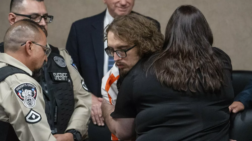 Adriana Zandri, widow of Ivan Manzano killed during the Walmart mass shooting, hugs defendant Patrick Crusius during a plea hearing in El Paso, Texas, Tuesday, April 22, 2025. (Omar Ornelas/Pool Photo via AP)