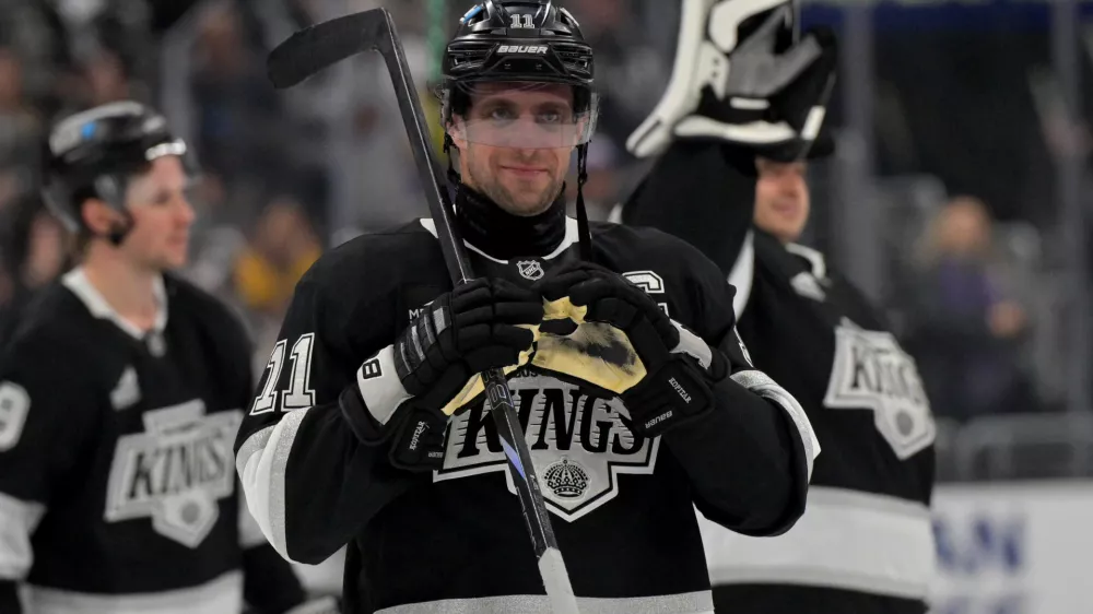 Apr 23, 2025; Los Angeles, California, USA; Los Angeles Kings center Anze Kopitar (11) makes a heart with his gloves for he daughter after defeating the Edmonton Oilers in game 2 of the 2025 Stanley Cup Playoffs at Crypto.com Arena. Mandatory Credit: Jayne Kamin-Oncea-Imagn Images