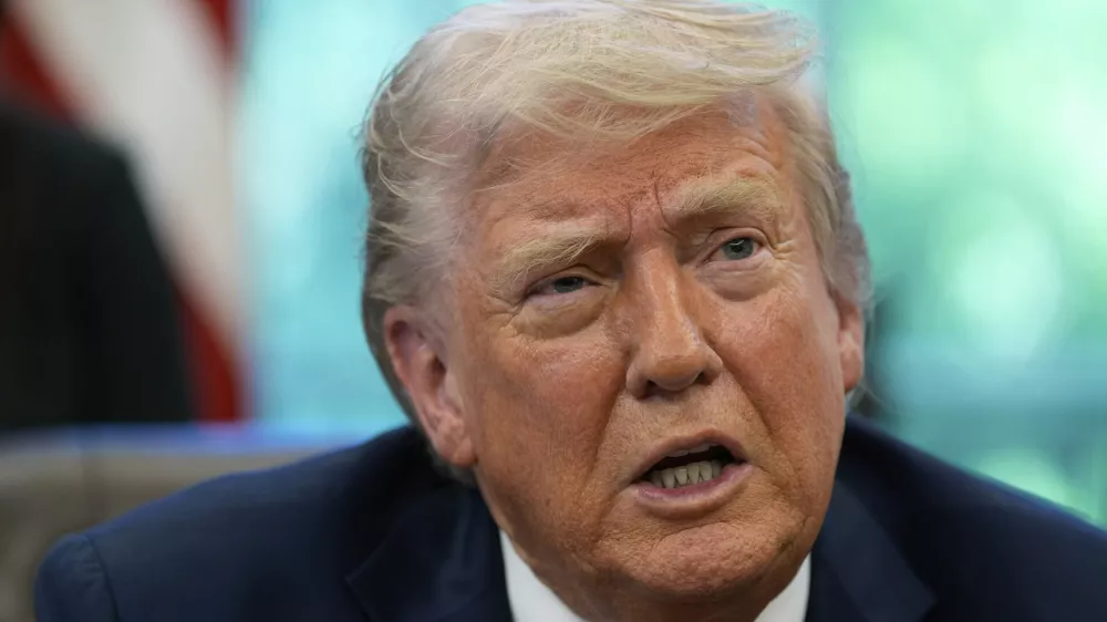 President Donald Trump speaks with reporters after signing executive orders in the Oval Office of the White House, Wednesday, April 23, 2025, in Washington. (AP Photo/Alex Brandon)