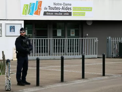 French police stands in front of the Notre-Dame-de-Toutes-Aides school after one high school student was killed and other students injured in a school stabbing, in Nantes, France, April 24, 2025. REUTERS/Stephane Mahe