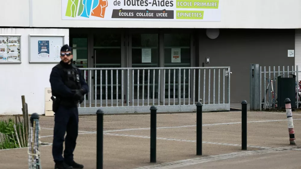 French police stands in front of the Notre-Dame-de-Toutes-Aides school after one high school student was killed and other students injured in a school stabbing, in Nantes, France, April 24, 2025. REUTERS/Stephane Mahe
