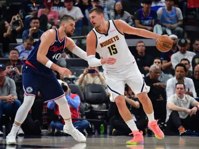 Apr 24, 2025; Inglewood, California, USA; Denver Nuggets center Nikola Jokic (15) controls the ball against Los Angeles Clippers center Ivica Zubac (40) during the second half of game three in the first round for the 2024 NBA Playoffs at Intuit Dome. Mandatory Credit: Gary A. Vasquez-Imagn Images