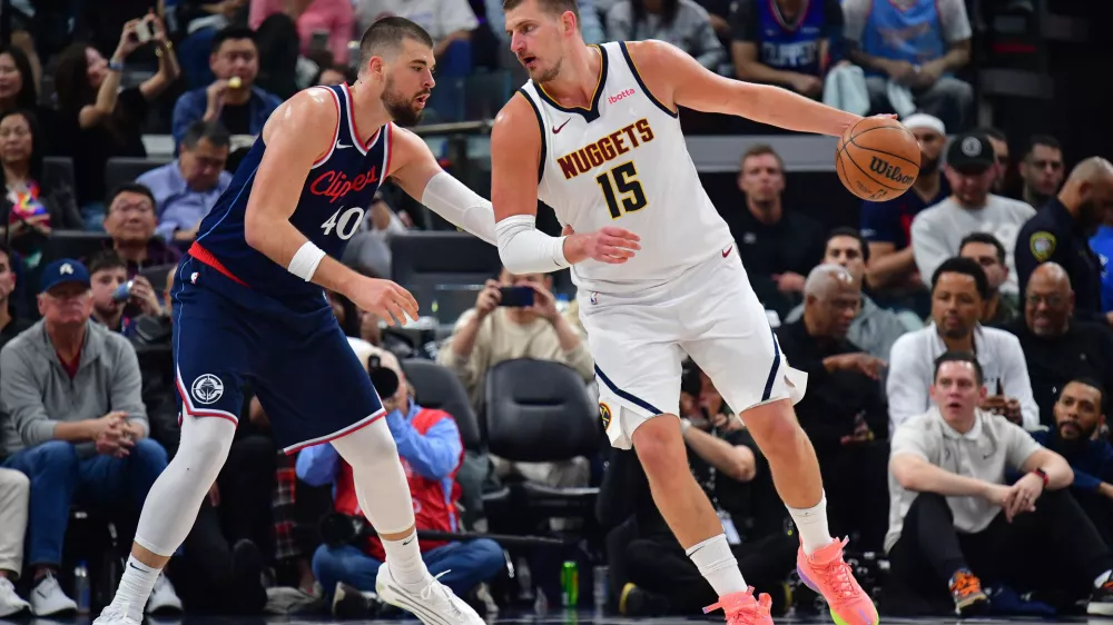 Apr 24, 2025; Inglewood, California, USA; Denver Nuggets center Nikola Jokic (15) controls the ball against Los Angeles Clippers center Ivica Zubac (40) during the second half of game three in the first round for the 2024 NBA Playoffs at Intuit Dome. Mandatory Credit: Gary A. Vasquez-Imagn Images