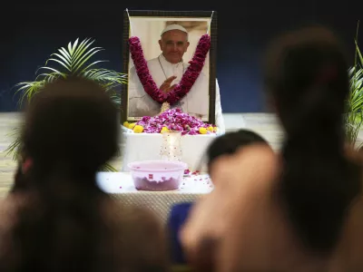 People pay tribute to Pope Francis in Ahmedabad, India, Friday, April 25, 2025. (AP Photo/Ajit Solanki)