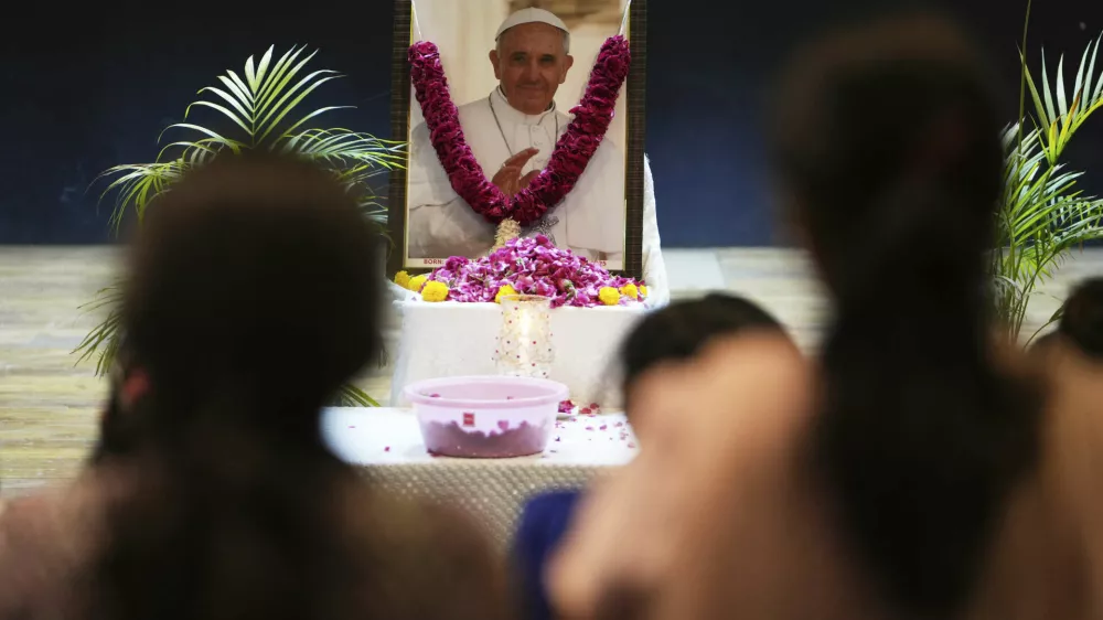 People pay tribute to Pope Francis in Ahmedabad, India, Friday, April 25, 2025. (AP Photo/Ajit Solanki)